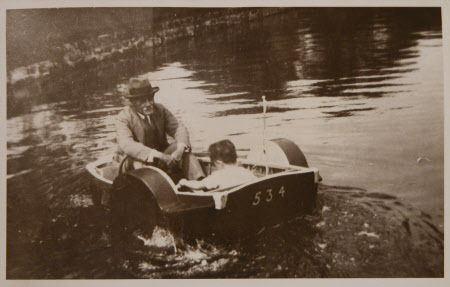 Rudyard Kipling (1865-1936) boating with a young friend on the pond at Bateman's