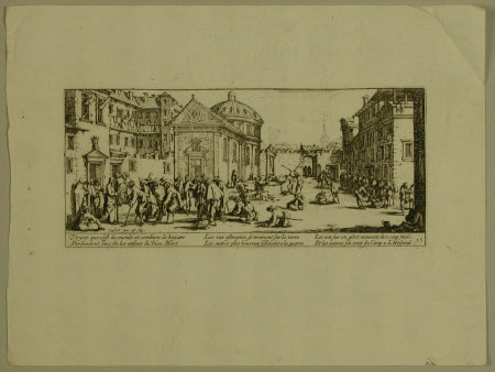 Injured men in the courtyard of a hospital.