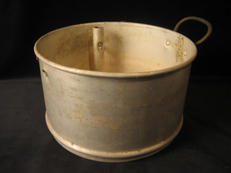 A lid and two aluminium stacking steamer pans with steam regulator valves.