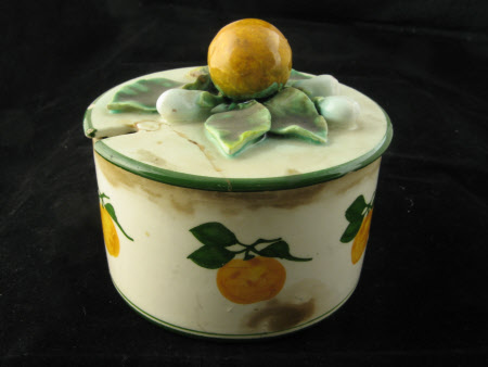 Four preserve pots with lids and associated plates.