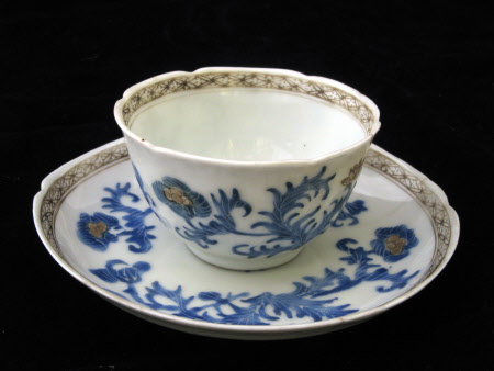 A pair of small 18th century eggshell tea bowls and saucers.