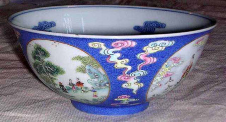 A pair of Chinese blue ground famille rose medallion bowls on stands.