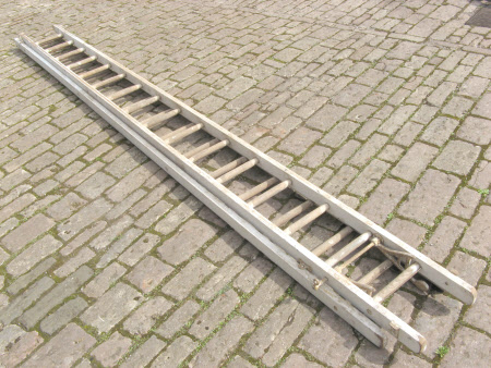 Wooden extending ladder in two sections.