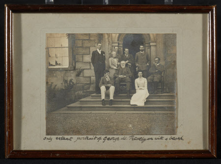 A famed photograph of a group outside the front door of Wallington. The photograph includes George ...