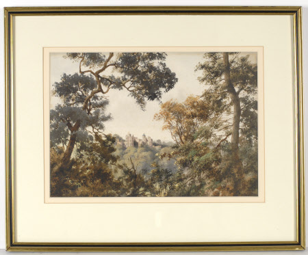 Dunster Castle seen through trees from the North-West