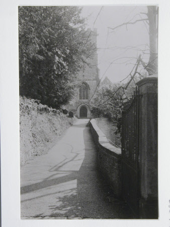 View through gate on path of the Tower of Parish church of St Peter, Dyrham, Gloucestershire