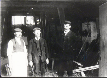 Left to right ; Fred King, Frank Hardy (bailiff), Fred Moss. Carpenters shop, Dyrham Park, ...