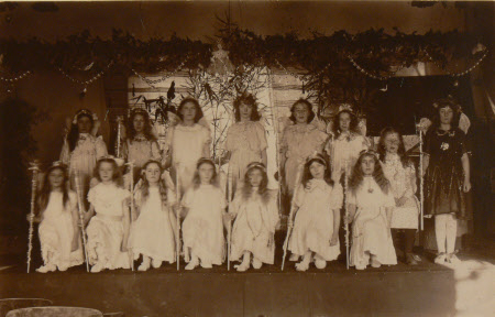 Village school girls dressed in white holding wands, Dyrham School, Gloucestershire