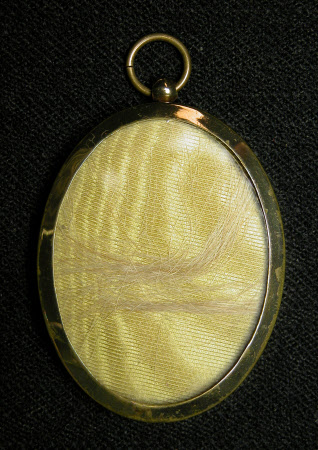 An oval gilt metal locket circa 1900.
