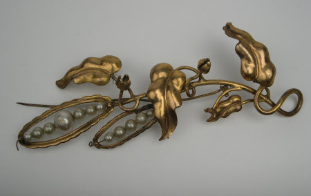 A Victorian gilt metal and imitation pearl brooch.