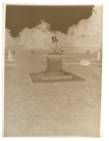 The statue of Cupid on a plinth in the parterre (Dutch Garden) at the east front of Kingston Lacy