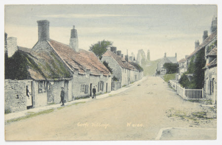 View along West Street, Corfe Castle village with castle in distance