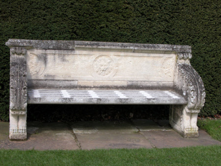 Carved Stone Seat with Acanthus decoration and a central Medallion of a Lion's Head