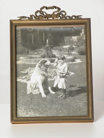 Philip Yorke III (1905-1978) as a child with a clay pigeon and a large dog.