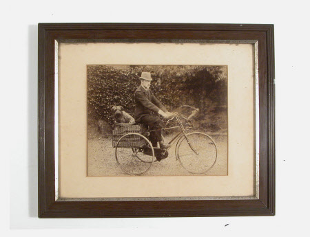Philip Yorke II (1849-1922)  on tricycle, with dog.