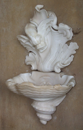 Wall-font: shell basin with dolphin head