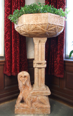Holy water stoup supported on a Grotesque Lion