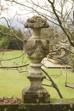 A fruit-headed urn overflowing with apples, the body of the urn adorned with swags