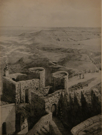 View of the Keep of Bamburgh Castle, looking down on the gate and across the dunes to the sea.