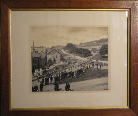 Rothbury village, Northumberland, with the Northumberland Hussars marching towards the church led ...