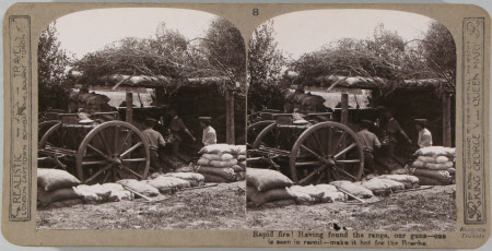 Rapid fire! Having found the range, our guns - one seen in recoil - make it hot for the Bosche.