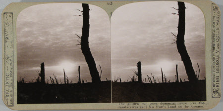 The Golden sun goes down in peace o'er the desolate waste of No man's Land on the Somme.