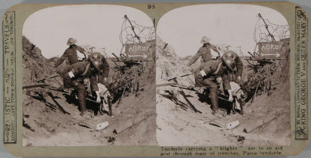 Tenderly carrying a "blighty" case to an aid post through the maze of trenches at Passchendaele.