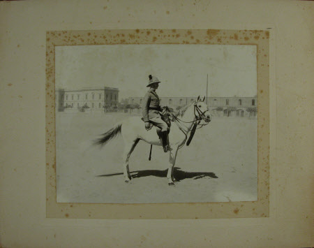 Unknown gentleman in uniform on a white horse