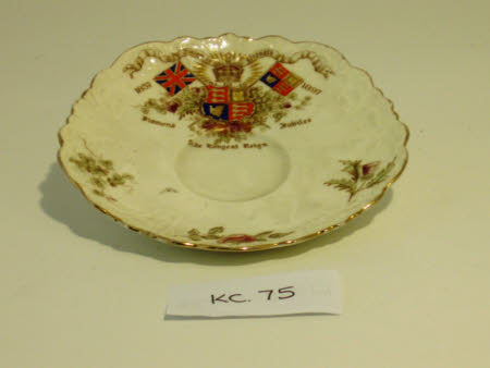 A white commemorative saucer marking Queen Victoria's Diamond Jubilee in 1897.