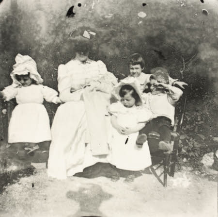 Hester Rogers, Mrs Marwood Coad, with her children, sitting holding a baby, Wilfred Coad, on her ...