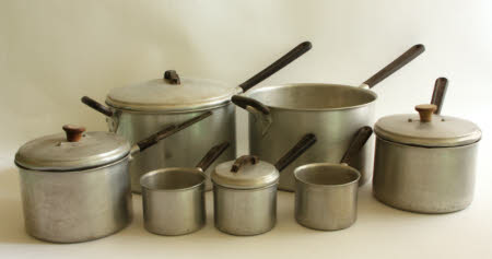 A collection of six saucepans with lids.