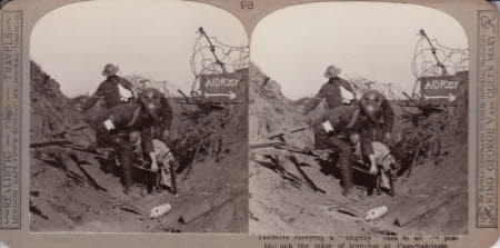 Tenderly carrying a 'Blighty' case to an aid post through the maze of trenches at Passchendaele.