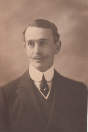 Portrait photograph of Peter Kerr-Smiley, wearing dark suit and looking away from the camera