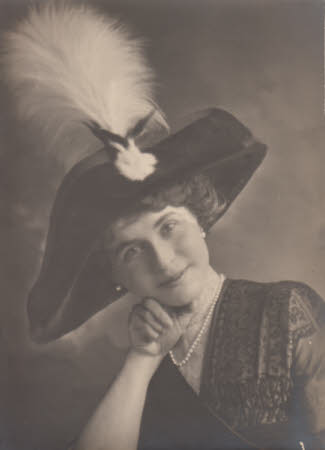 Photograph of Maud Kerr-Smiley, resting on one arm, with hat.