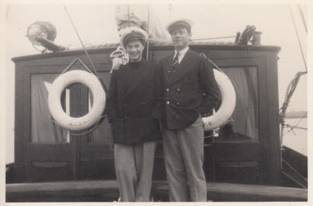 Elizabeth Hussey dressed in mens clothes, standing on a boat with a man