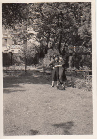 Elizabeth Hussey in a garden with a woman and a dog