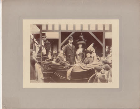 Photograph of Peter and Maud Kerr-Smiley standing in a crowded street next to an open topped car.