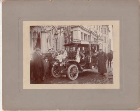Street scene with car proclaiming a victory in the election for Smiley.  Maud and Peter Kerr-Smiley ...