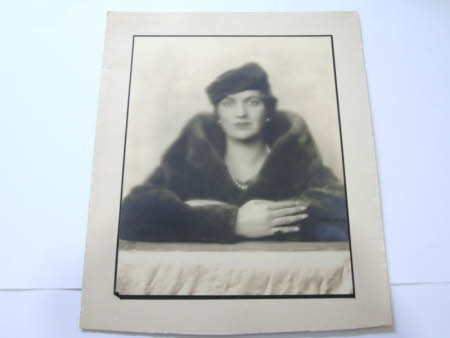 Photograph portrait of Elizabeth Hussey, arms resting on a flat surface, wearing a fur coat, ...