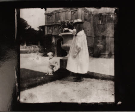 The Hon. Constance Margaret Agar- Robartes (1890-1936) with a terrier, in front of the Gatehouse, ...