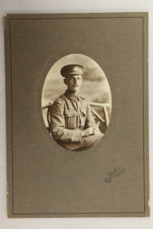 Unknown First World War soldier sitting on a wooden bench