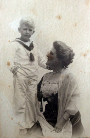 A lady and a young boy in a sailor suit.