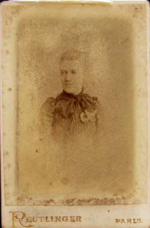 A young woman wearing a dark dress with corsage.
