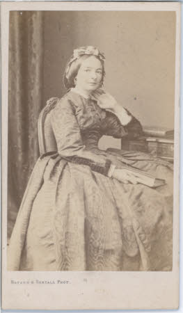 A full length portrait of a seated lady