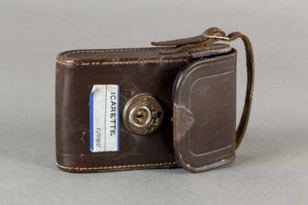 A brown leather carrying case for Icarette folding roll-film camera.