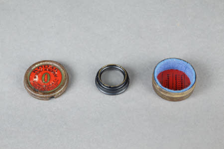 A Kodak Portrait Attachment  being a round metal box with glass lens
