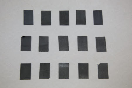 15 strips of black backing paper for Le Photo-Revolver camera plate holders.