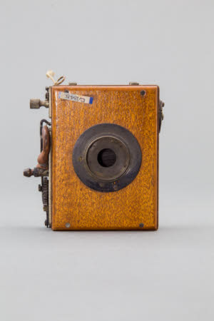 Roller-blind shutter attachment for folding field camera.