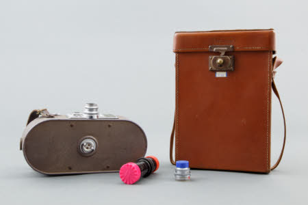 A Keystone A7 cine camera, with two additional lenses and a leather carrying case.