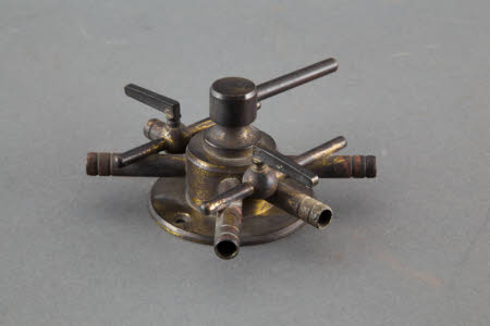 Brass Star Six-Way Dissolver taps for control of gas to illuminant.